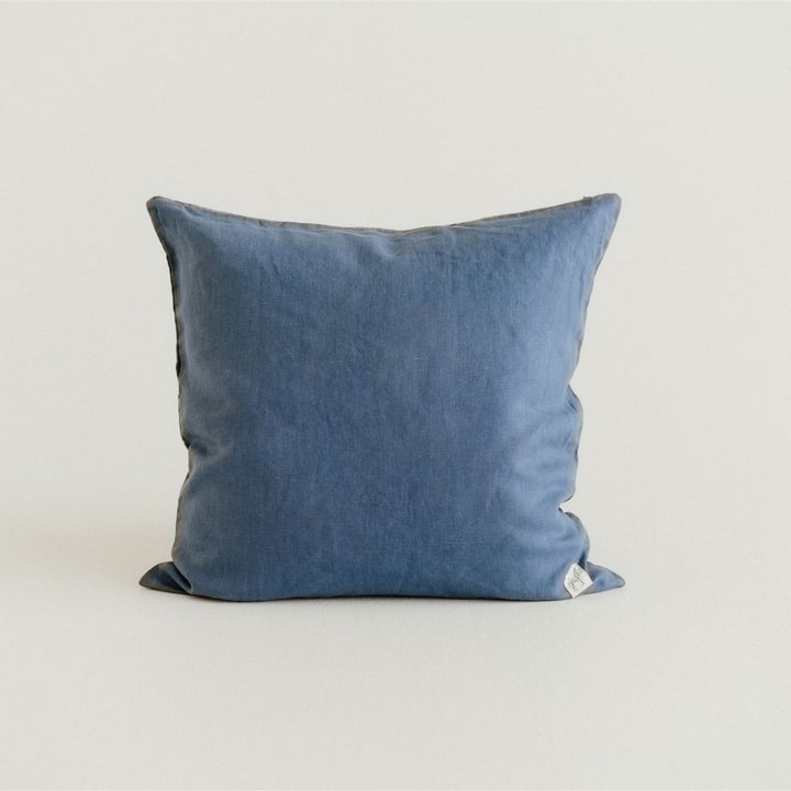in a bedroom with Coastal Blue Cushion Cover.
