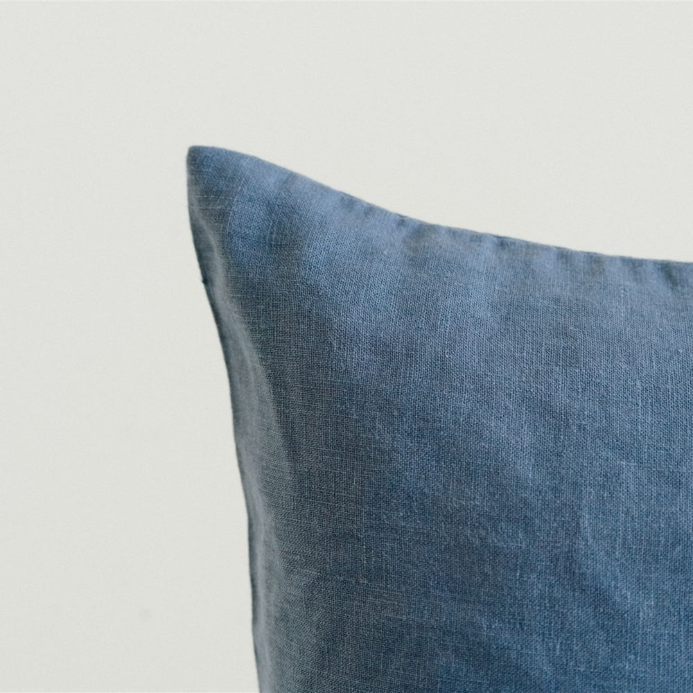 in a bedroom with Coastal Blue Cushion Cover.