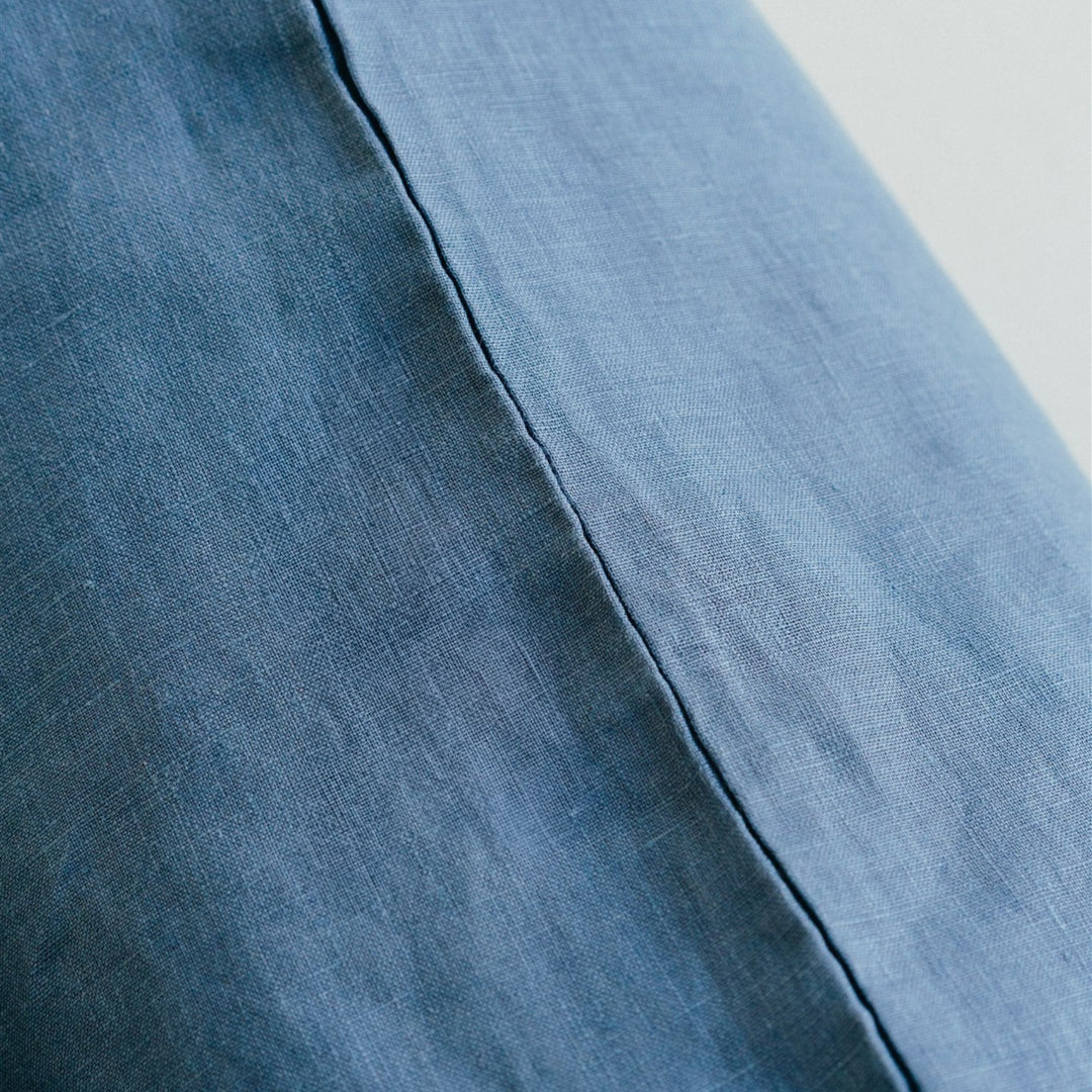 in a bedroom with Coastal Blue Cushion Cover.