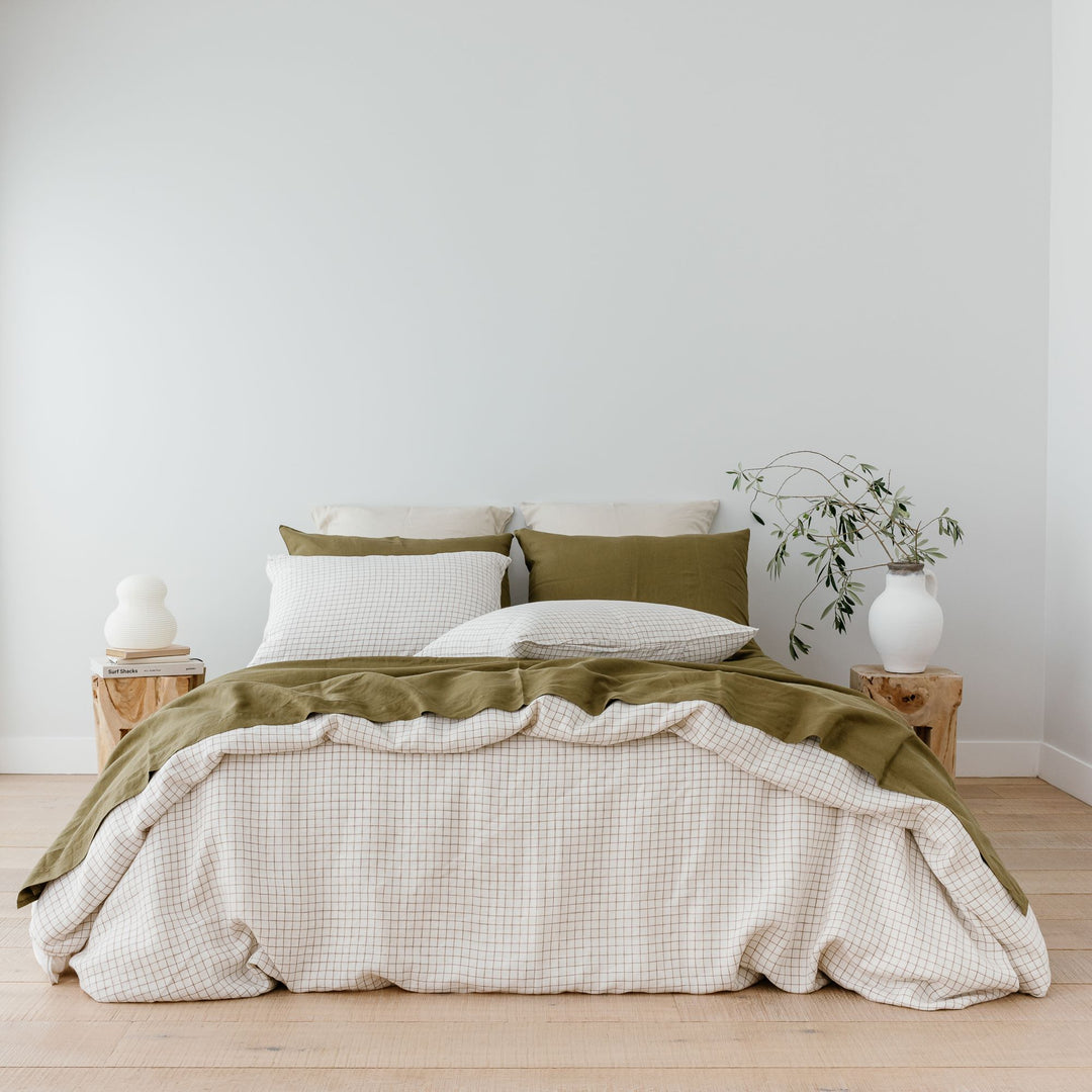 Foxtrot Home French Flax Linen styled with a Malt Brown Grid Duvet and Olive Sheets