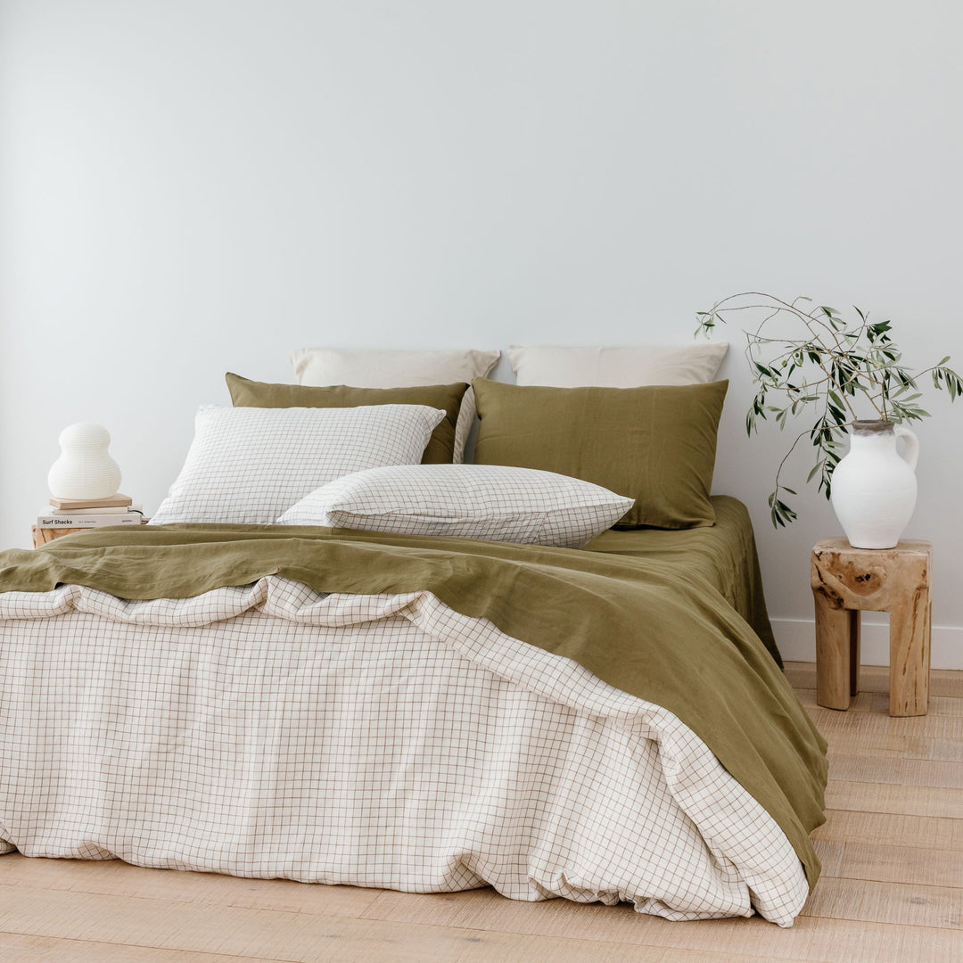 Foxtrot Home French Flax Linen styled with a Malt Brown Grid Duvet and Olive Sheets