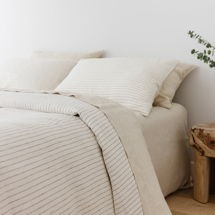 Foxtrot Home French Flax Linen Oat Sheet Sets styled in a bedroom.