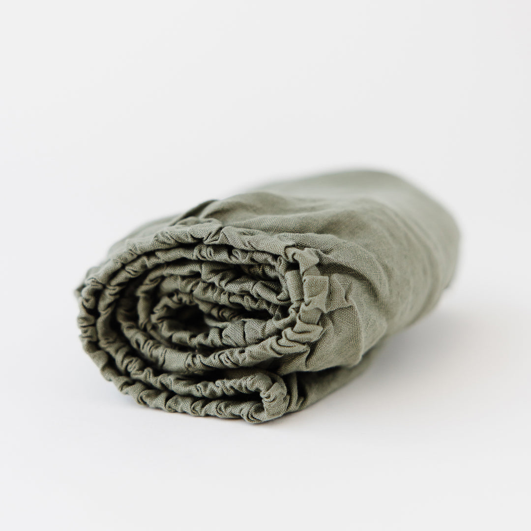 Foxtrot Home French Flax Linen styled in a baby's bedroom with Cactus Cot Sheet and Bassinet Sheets.