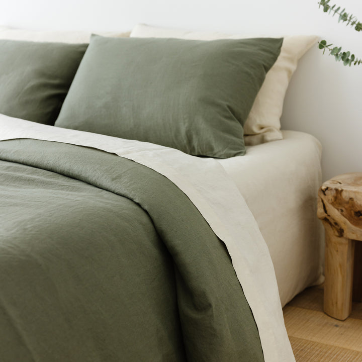 Foxtrot Home French Flax Linen styled in a bedroom with Cactus Green Duvet, Oat Sheets Set and Pillowcases.