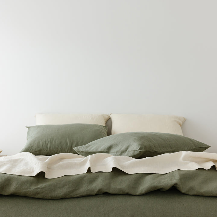 Foxtrot Home French Flax Linen styled in a bedroom with Cactus Green Duvet, Oat Sheets Set and Pillowcases.