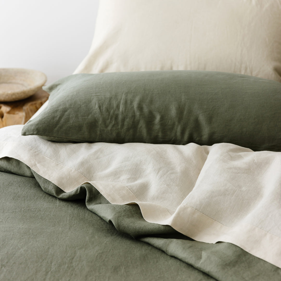 Foxtrot Home French Flax Linen styled in a bedroom with Cactus Green Duvet, Oat Sheets Set and Pillowcases.