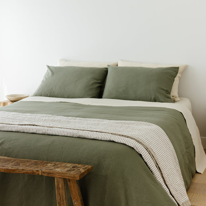 Foxtrot Home French Flax Linen styled in a bedroom with Cactus Green Duvet, Oat Sheets Set and Pillowcases.