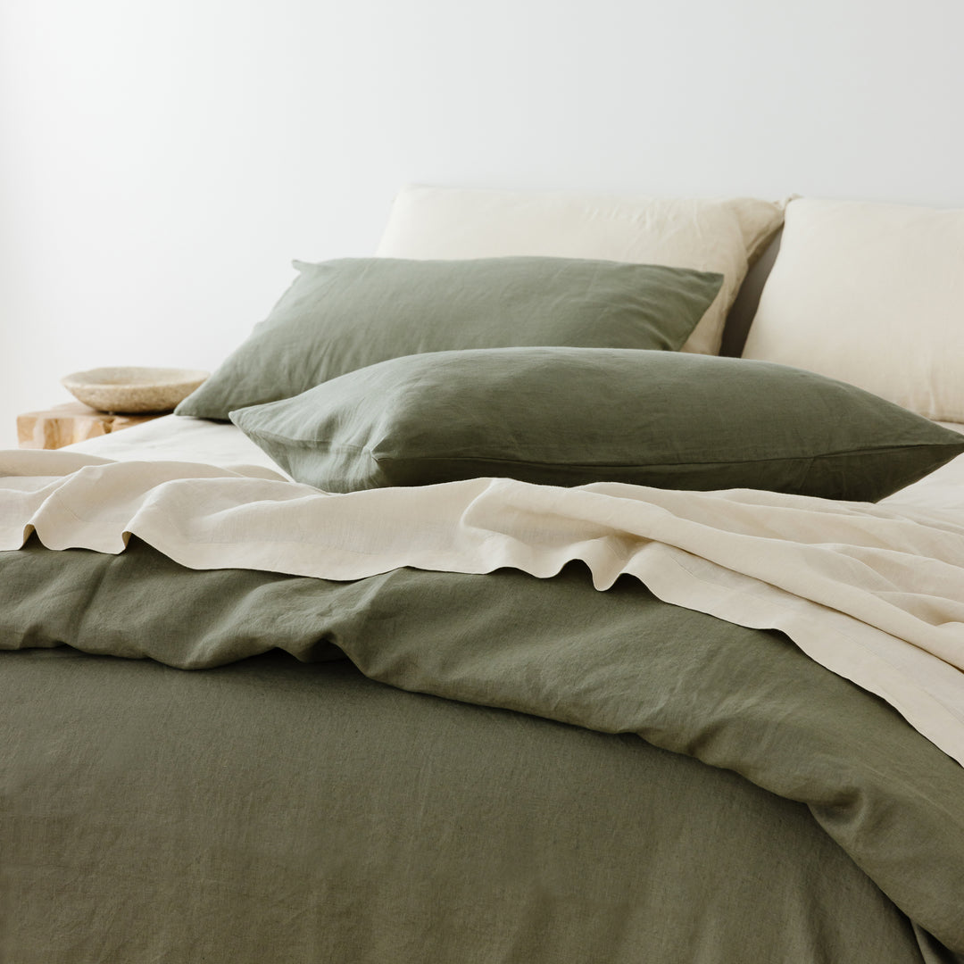 Foxtrot Home French Flax Linen styled in a bedroom with Cactus Green Duvet, Oat Sheets Set and Pillowcases.