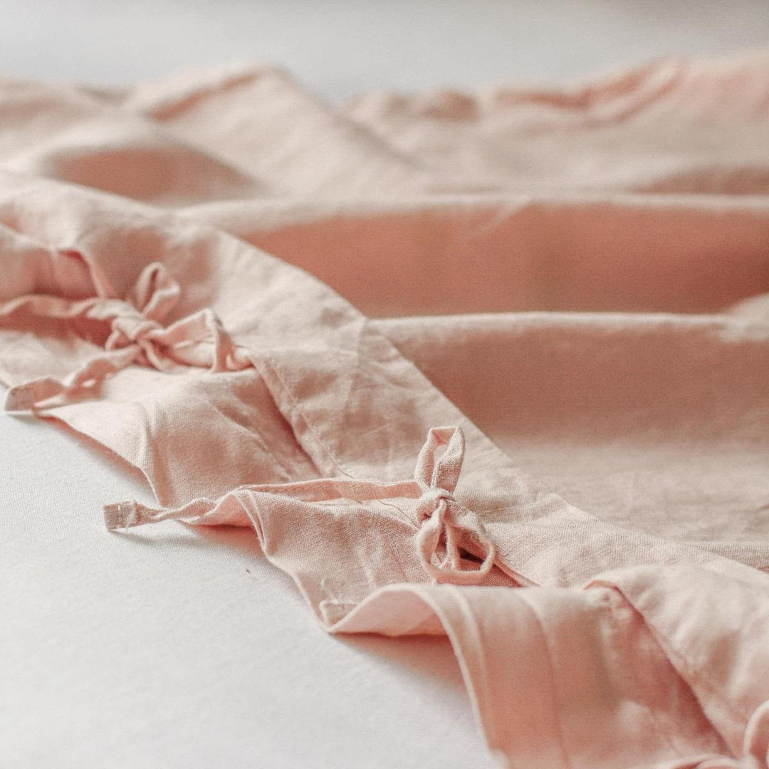 Foxtrot Home French Flax Linen styled in a baby's bedroom with a Blush Pink Cot Duvet.