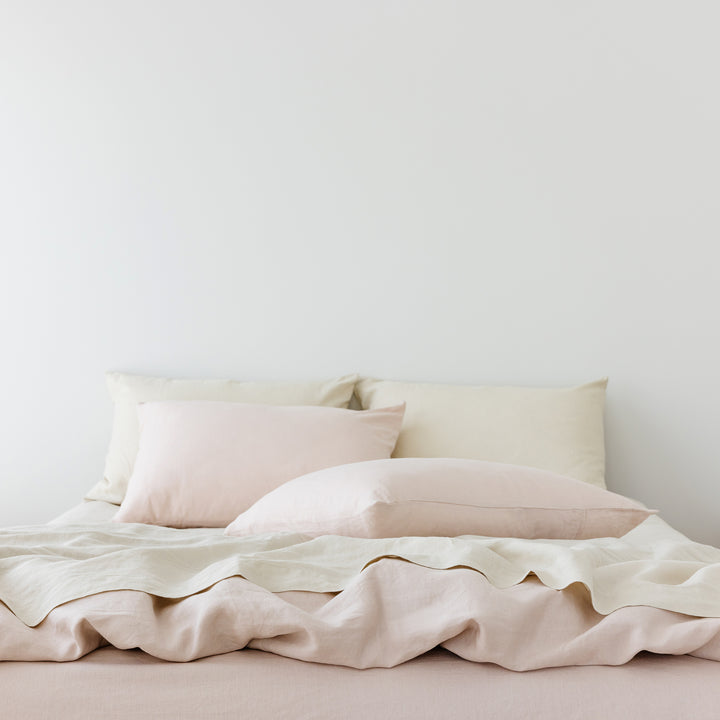 Foxtrot Home French Flax Linen styled in a bedroom with Blush Pink Duvet, Oat Sheets Set and Pillowcases.