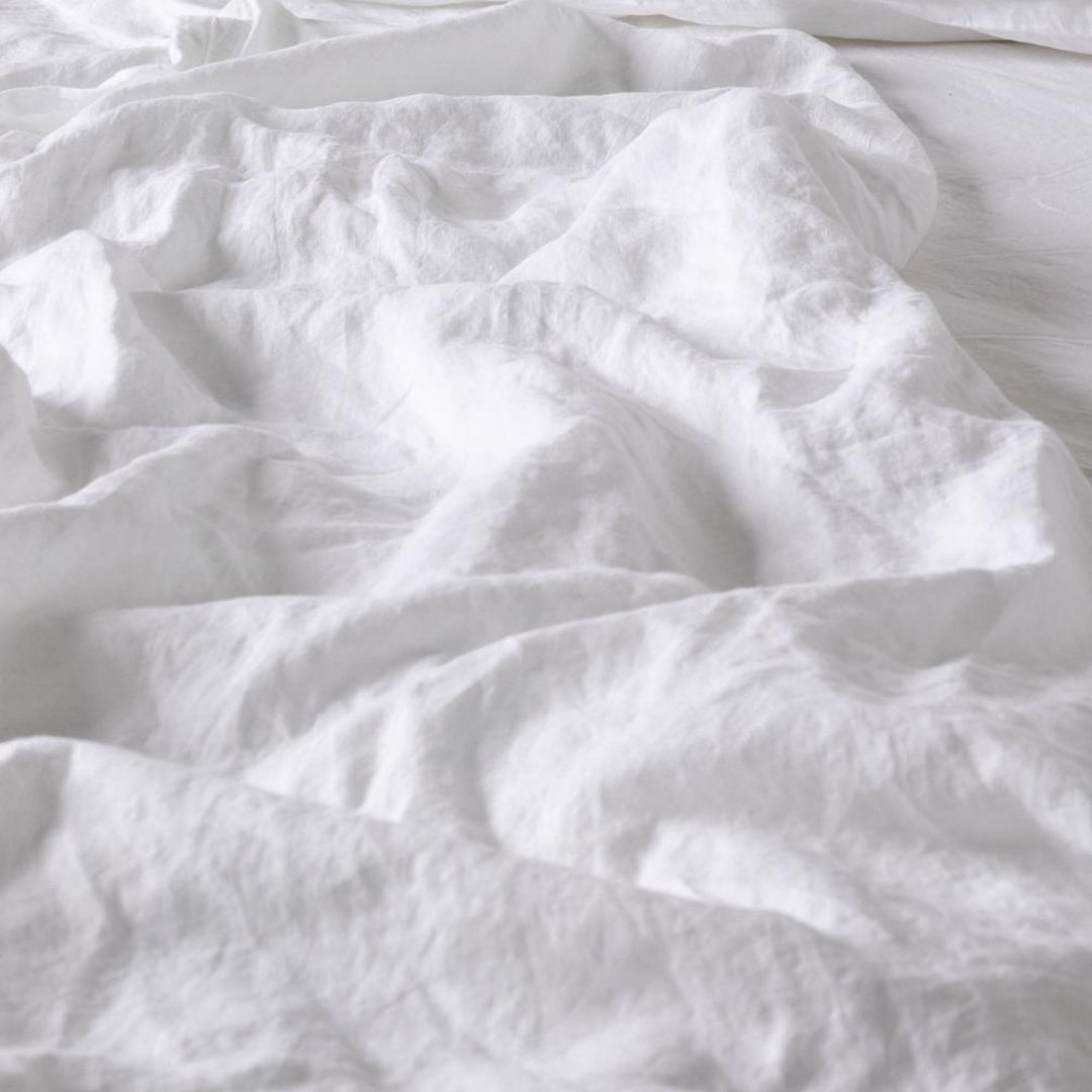 Foxtrot Home French Flax Linen styled in a baby's bedroom with a Brilliant White Cot Duvet.