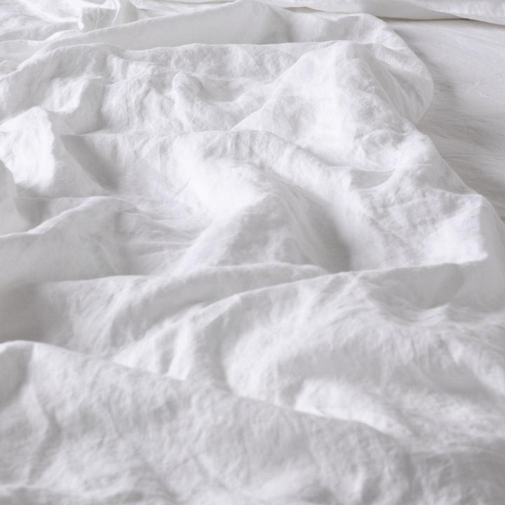 Foxtrot Home French Flax Linen styled in a baby's bedroom with a Brilliant White Cot Duvet.