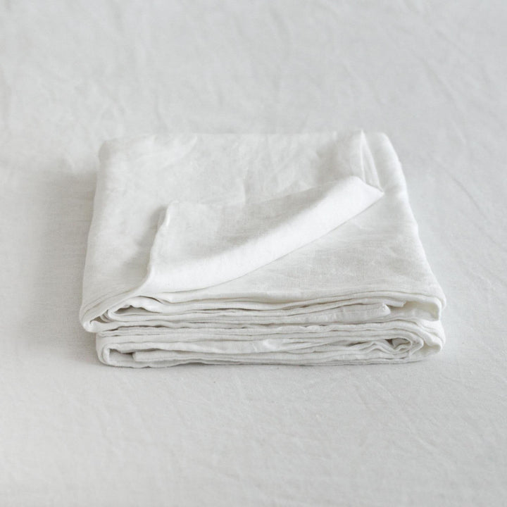 Foxtrot Home French Flax Linen styled in a bedroom with Brilliant White Pillowcases.