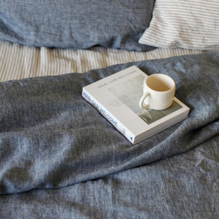 Foxtrot Home French Flax Linen styled in a bedroom with Denim Blue Duvet.