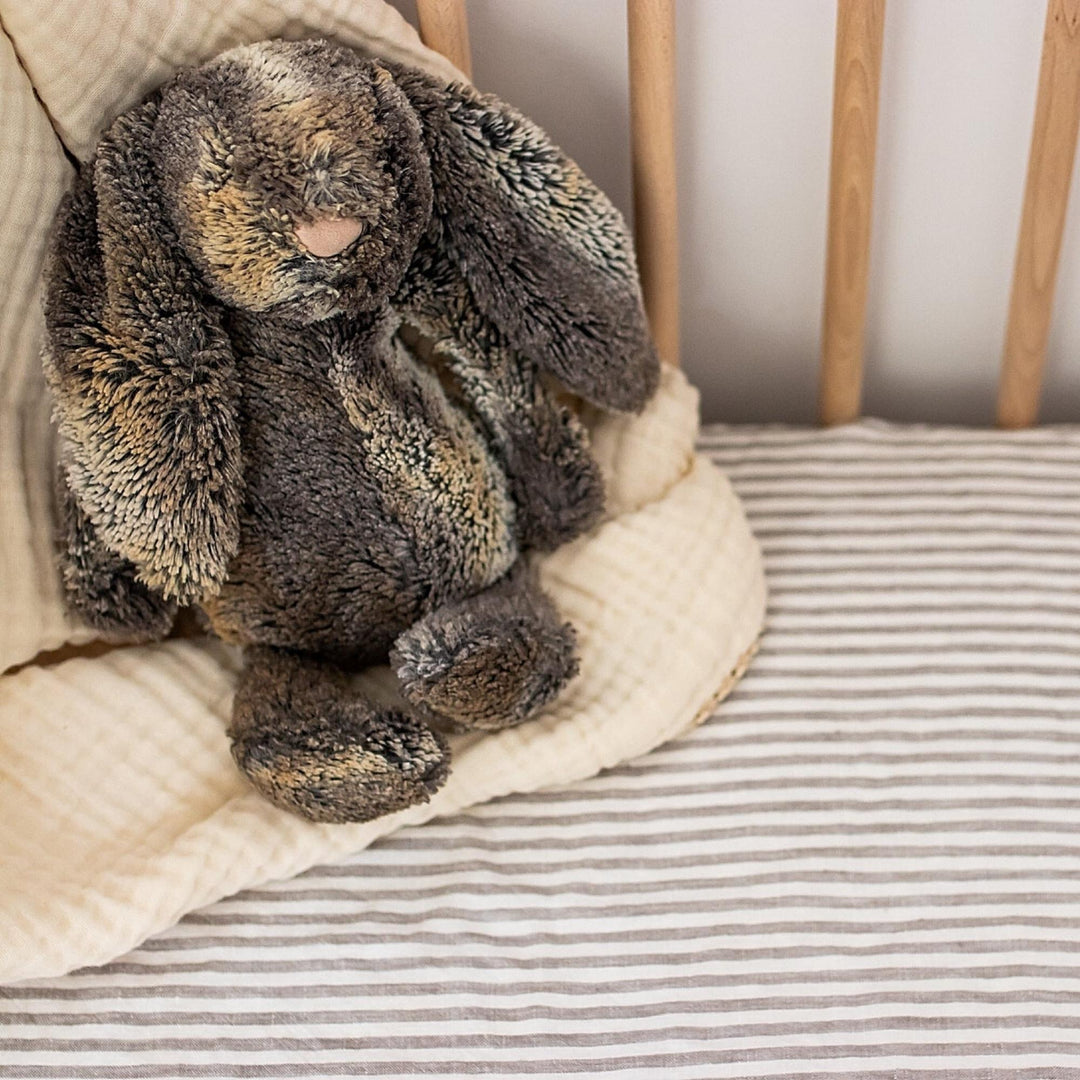 Foxtrot Home French Flax Linen styled in a baby's bedroom with Grey Stripes Cot Sheet and Bassinet Sheets.