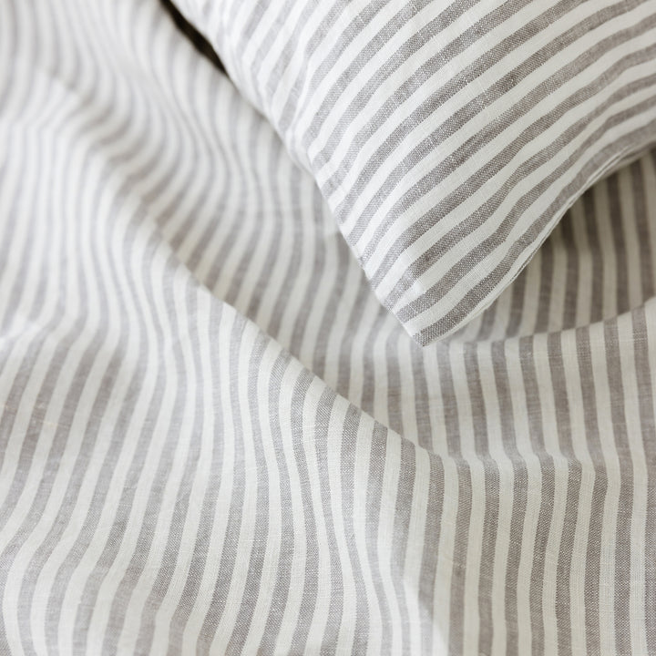 Foxtrot Home French Flax Linen styled in a bedroom with Grey Stripes Duvet.