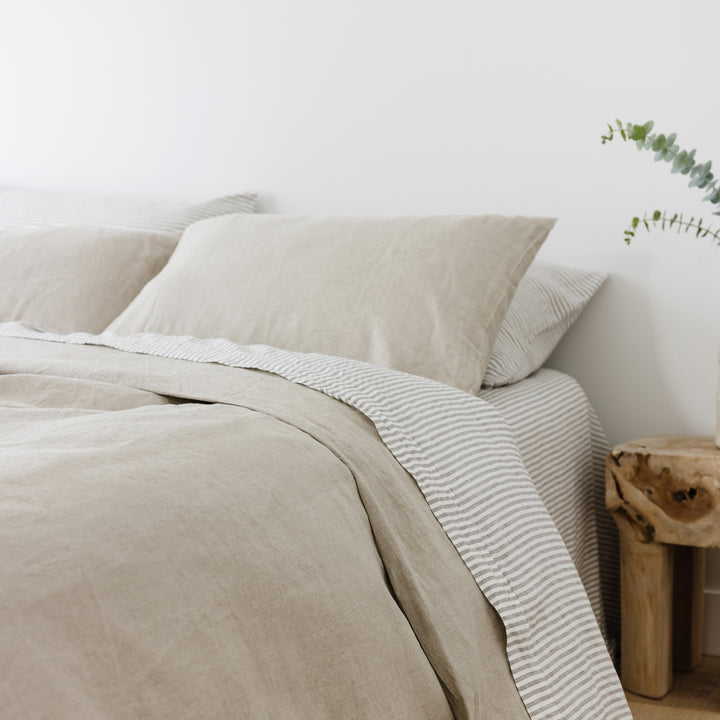 Foxtrot Home French Flax Linen styled in a bedroom with Grey Stripes Flat Sheet.