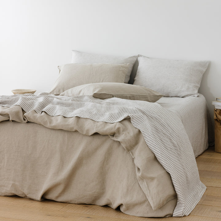 Foxtrot Home French Flax Linen styled in a bedroom with Grey Stripes Flat Sheet.