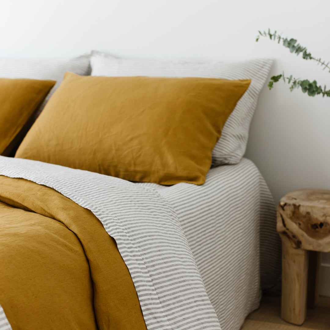 Foxtrot Home French Flax Linen styled in a bedroom with Grey Stripes Flat Sheet.