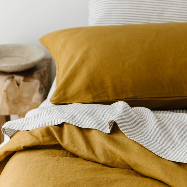 Foxtrot Home French Flax Linen styled in a bedroom with Grey Stripes Flat Sheet.