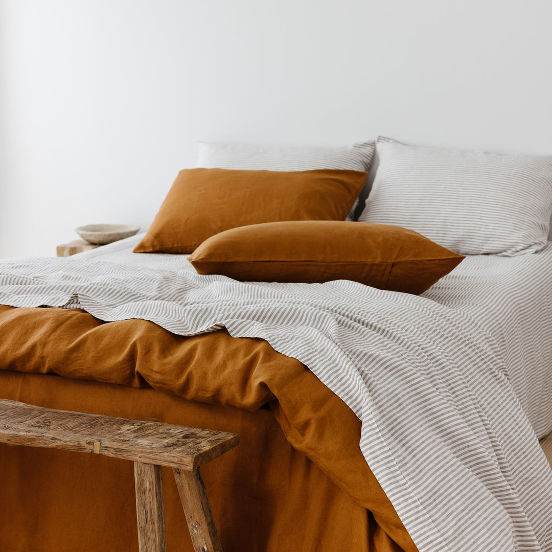 Foxtrot Home French Flax Linen styled in a bedroom with Grey Stripes Flat Sheet.