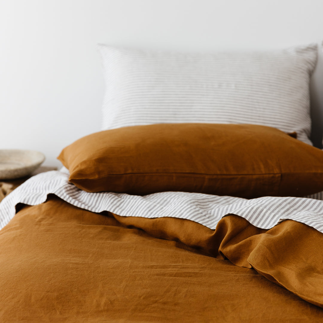 Foxtrot Home French Flax Linen styled in a bedroom with Grey Stripes Flat Sheet.