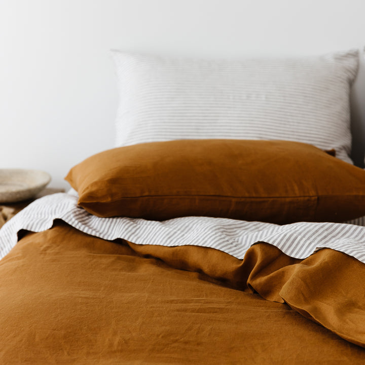 Foxtrot Home French Flax Linen styled in a bedroom with Grey Stripes Flat Sheet.