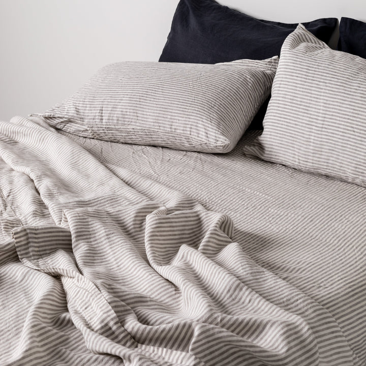 Foxtrot Home French Flax Linen styled in a bedroom with Grey Stripes Flat Sheet.