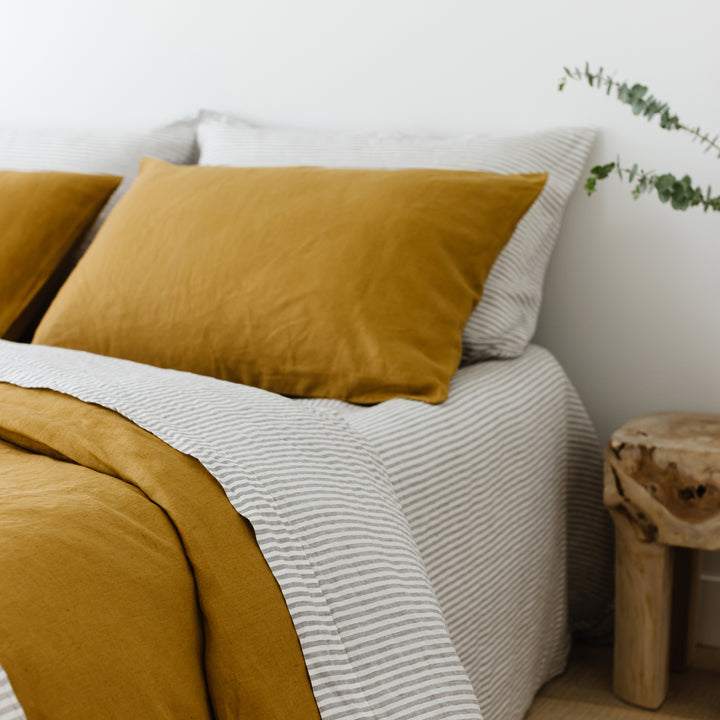 Foxtrot Home French Flax Linen styled in a bedroom with Grey Stripes Fitted Sheet.