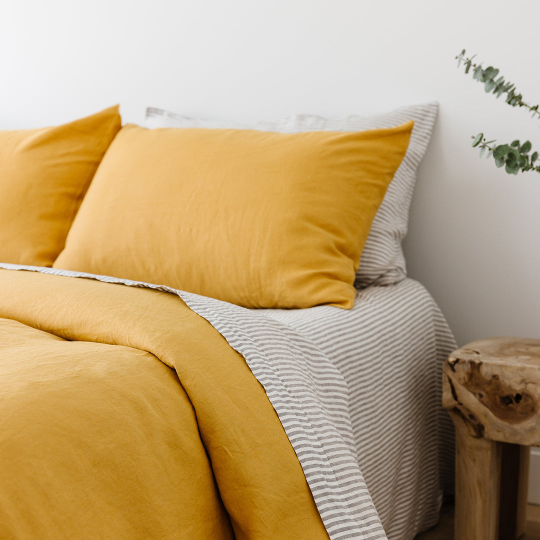 Foxtrot Home French Flax Linen styled in a bedroom with Grey Stripes Fitted Sheet.