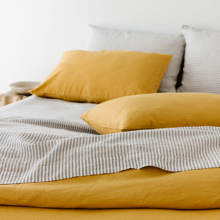 Foxtrot Home French Flax Linen styled in a bedroom with Grey Stripes Fitted Sheet.