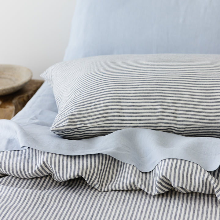 Foxtrot Home French Flax Linen styled in a bedroom with Navy Stripes Duvet.