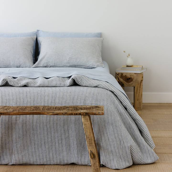 Foxtrot Home French Flax Linen styled in a bedroom with Navy Stripes Duvet.