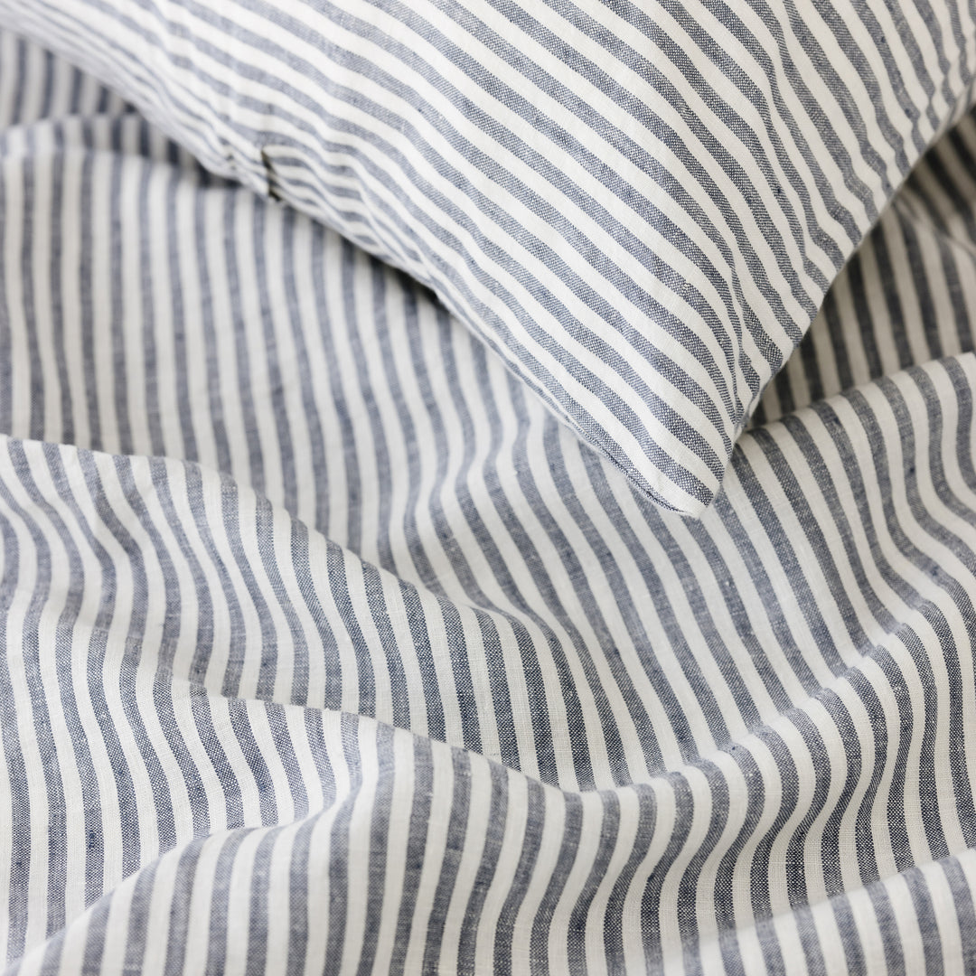 Foxtrot Home French Flax Linen styled in a bedroom with Navy Stripes Duvet.