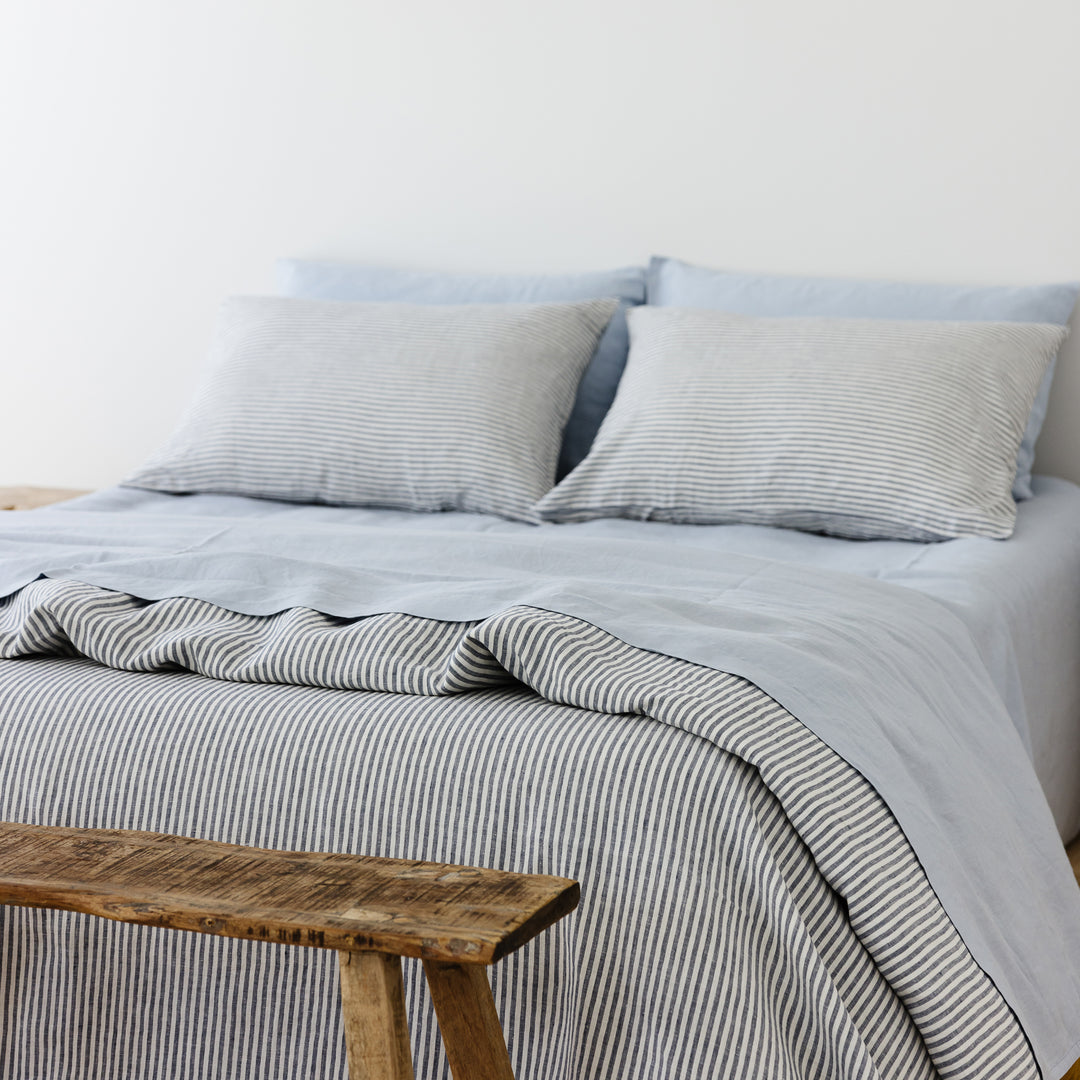 Foxtrot Home French Flax Linen styled in a bedroom with Navy Stripes Duvet.