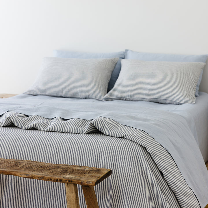 Foxtrot Home French Flax Linen styled in a bedroom with Navy Stripes Duvet.