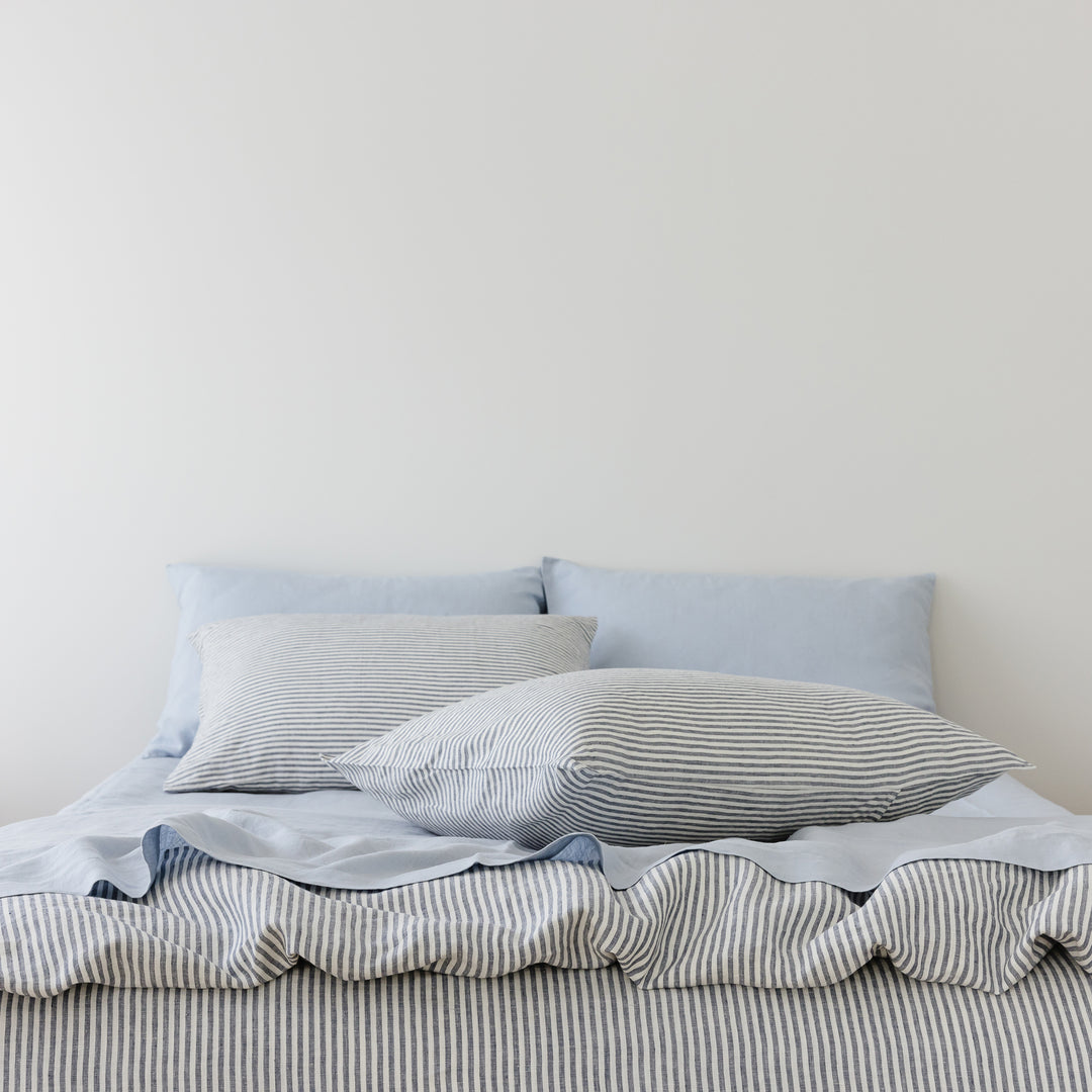 Foxtrot Home French Flax Linen styled in a bedroom with Navy Stripes Duvet.