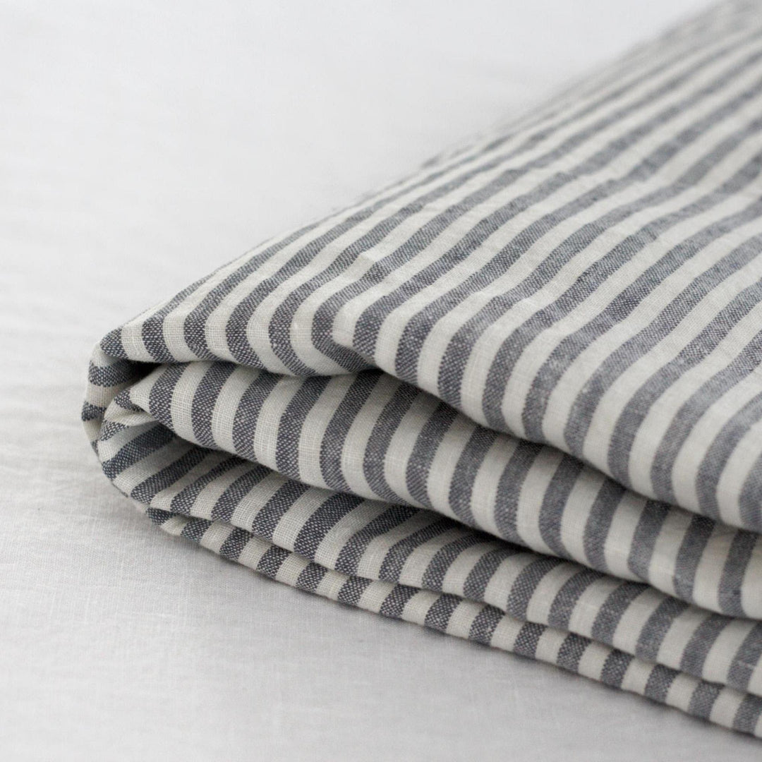 Foxtrot Home French Flax Linen styled in a bedroom with Navy Stripes Fitted Sheet.