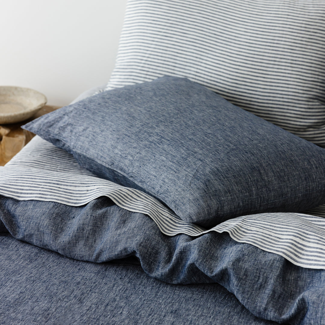 Foxtrot Home French Flax Linen styled in a bedroom with Navy Stripes Flat Sheet.