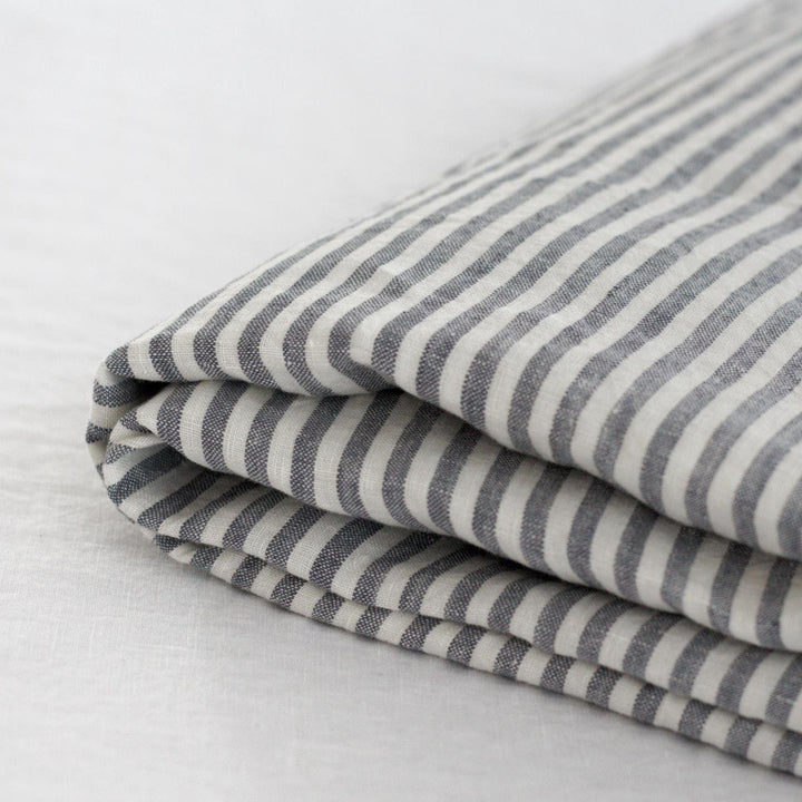 Foxtrot Home French Flax Linen styled in a bedroom with Navy Stripes Sheets Set.