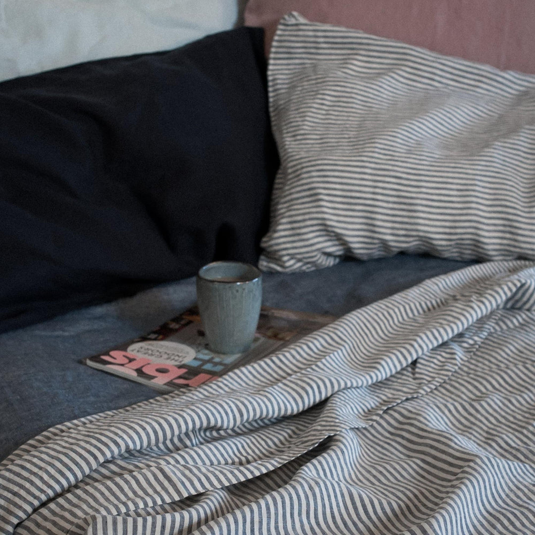 Foxtrot Home French Flax Linen styled in a bedroom with Navy Stripes Sheets Set.