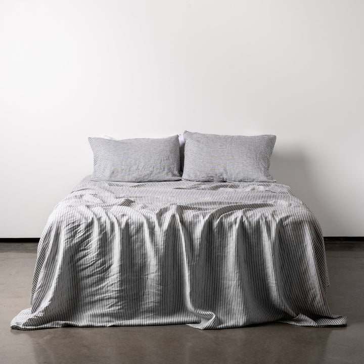 Foxtrot Home French Flax Linen styled in a bedroom with Navy Stripes Sheets Set.