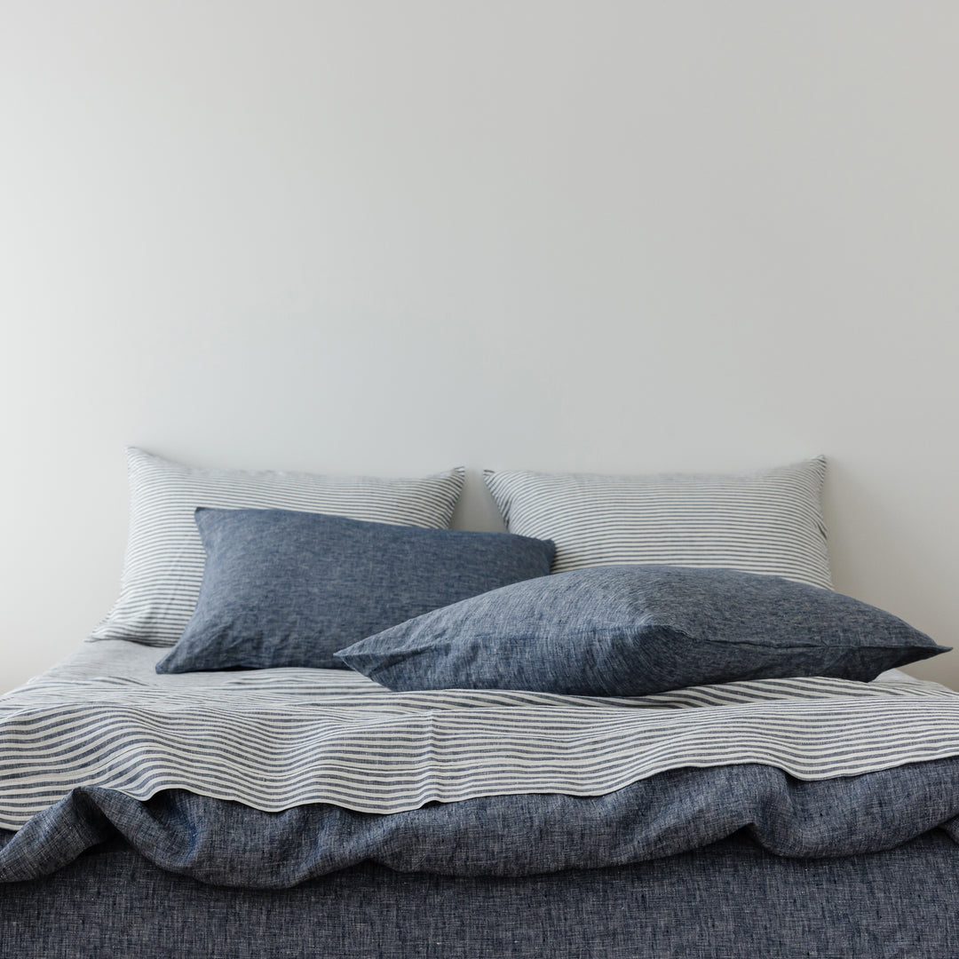 Foxtrot Home French Flax Linen styled in a bedroom with Navy Stripes Sheets Set.