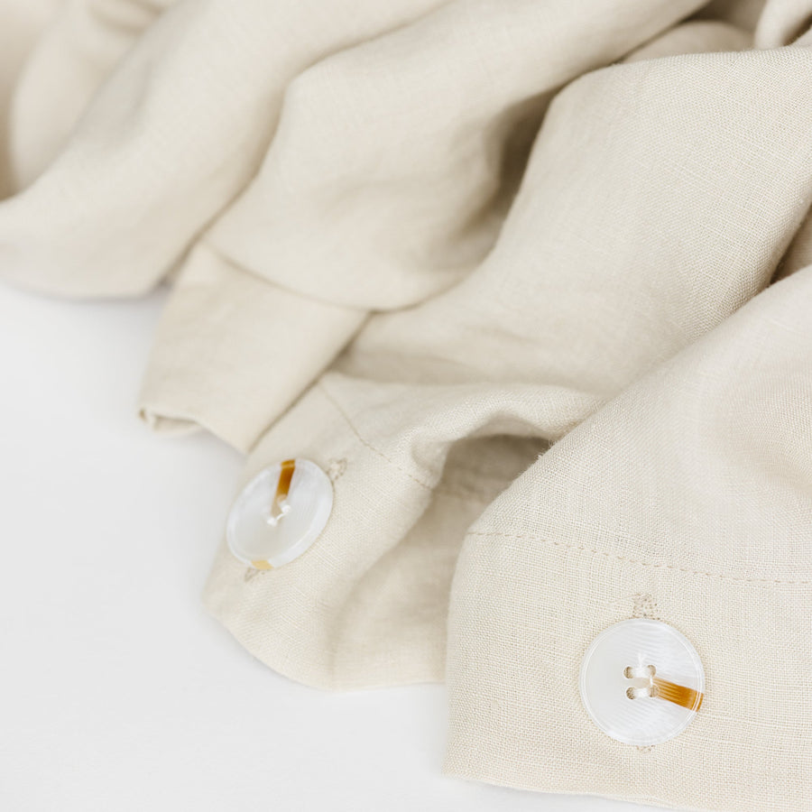 Foxtrot Home French Flax Linen styled in a bedroom with Oat Duvet.