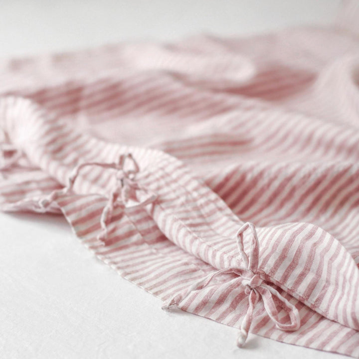 Foxtrot Home French Flax Linen styled in a baby's bedroom with a Pink Stripes Cot Duvet.