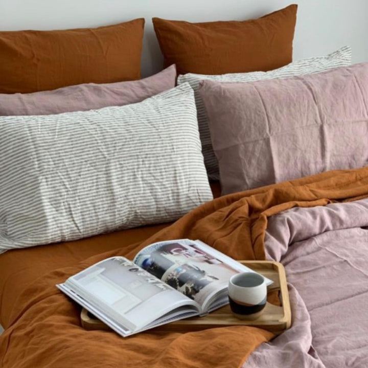 Foxtrot Home French Flax Linen styled in a bedroom with Rosewood Duvet, Grey Stripes and Pillowcases.