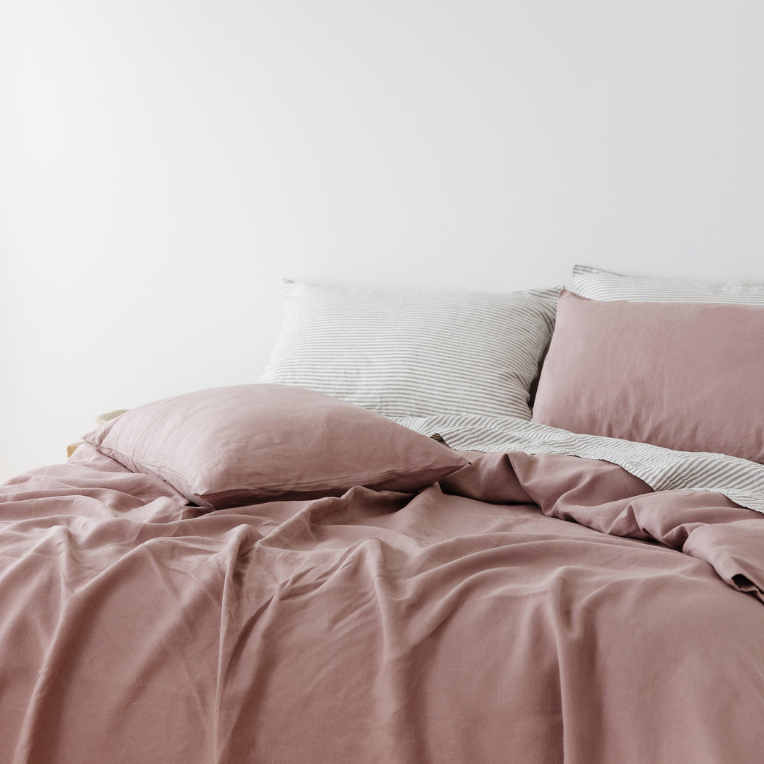 Foxtrot Home French Flax Linen styled in a bedroom with Rosewood Duvet, Grey Stripes and Pillowcases.