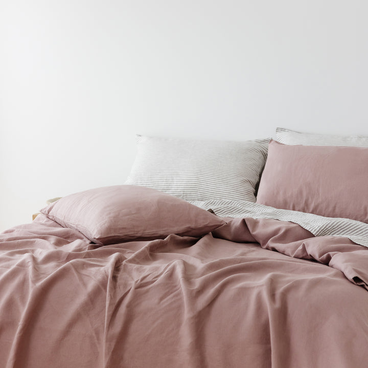 Foxtrot Home French Flax Linen styled in a bedroom with Rosewood Duvet, Grey Stripes and Pillowcases.
