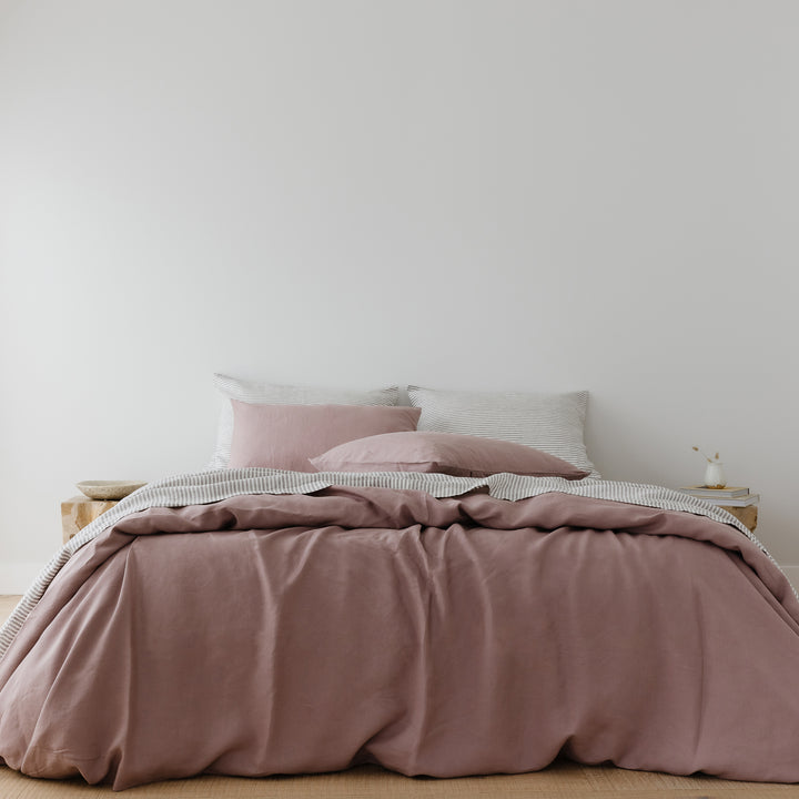 Foxtrot Home French Flax Linen styled in a bedroom with Rosewood Duvet, Grey Stripes and Pillowcases.