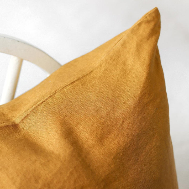 Foxtrot Home French Flax Linen styled in a bedroom with Ginger Honey Cushion Cover.